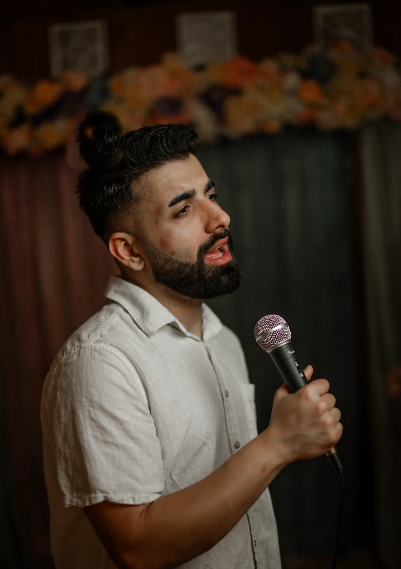 Ronkay singing live with a microphone